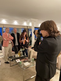 a man is taking a picture of a group of people in a living room